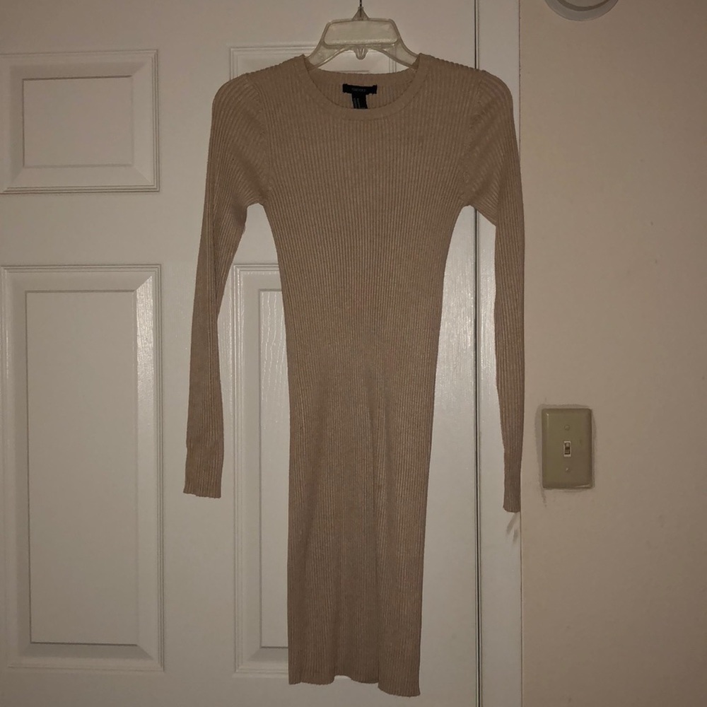 Nude, form fitting long sleeve dress.